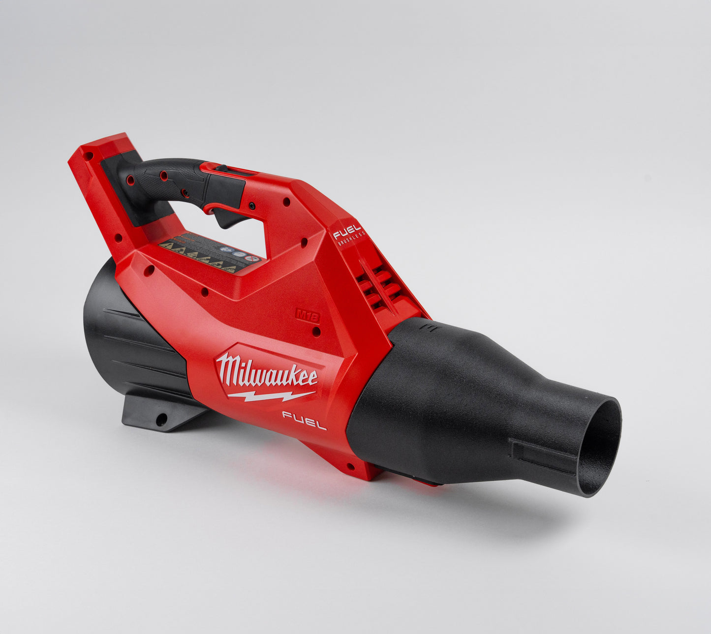 Full side view of the Milwaukee 3017-20 leaf blower fitted with the Arbite ShortFlow nozzle, shown resting on a flat surface.