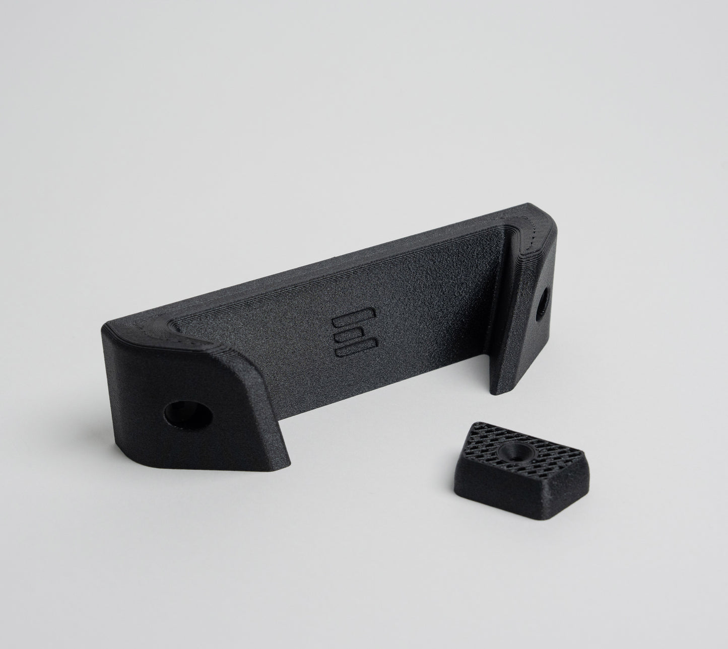 Milwaukee blower wall mount kit includes top bracket and bottom resting block for added tool stability.