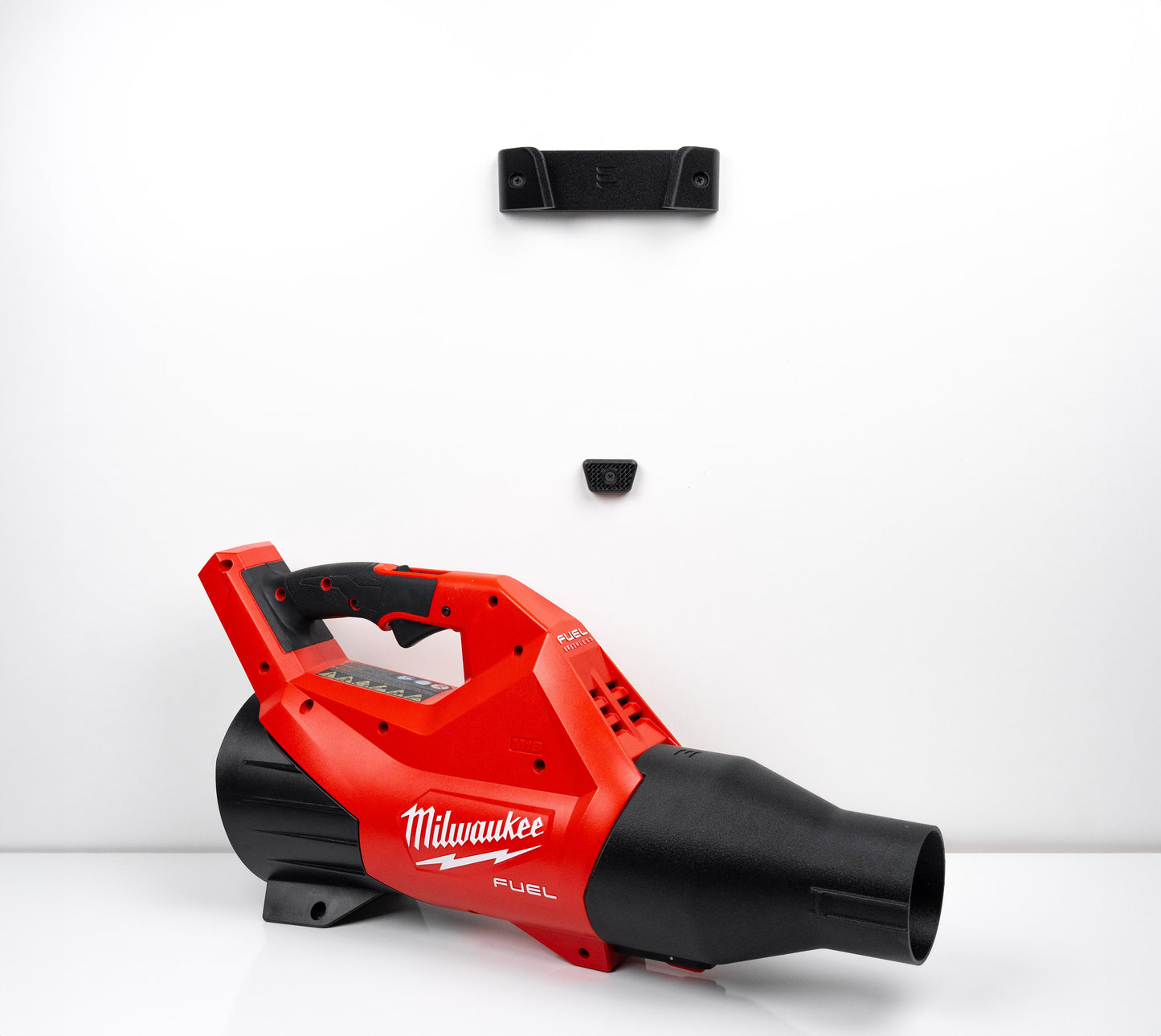 Complete wall mounting system for Milwaukee 3017-20 leaf blower showing both mount pieces and the tool resting beneath.