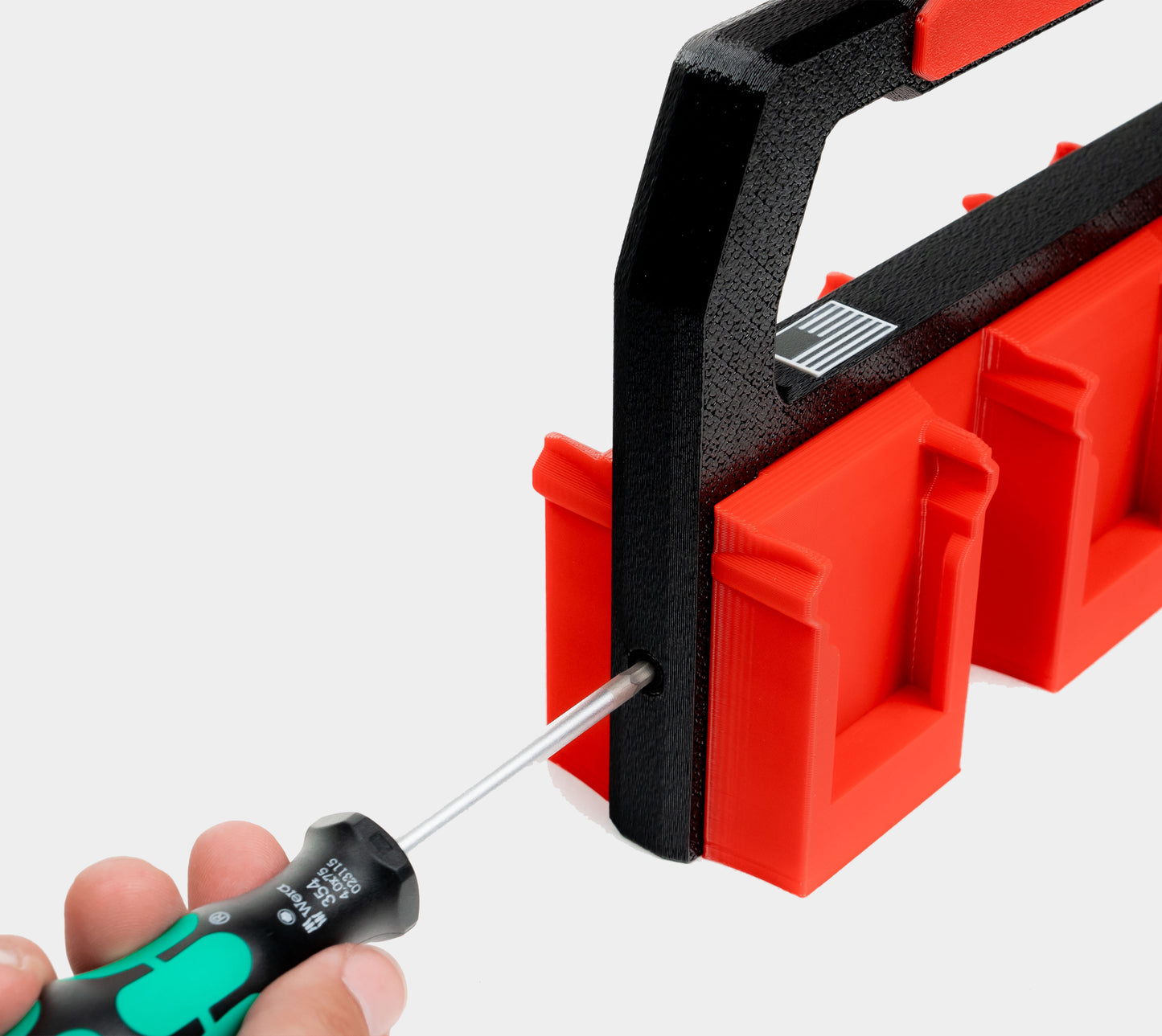 removing side bolt from Milwaukee Charge Pack handle to access hidden AirTag compartment