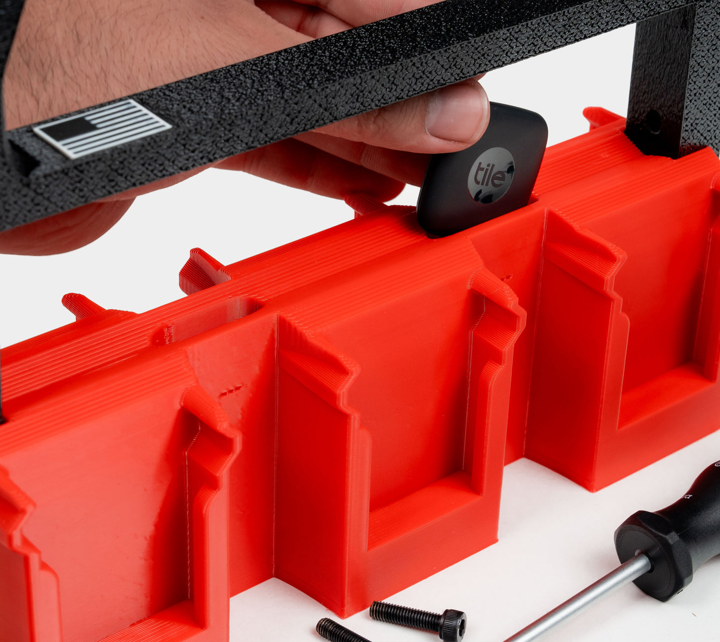Tile Tracker being inserted into hidden tracker pocket of Milwaukee battery pack