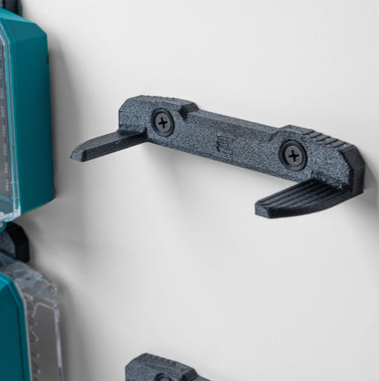 Full 4-pack wall mount kit displayed with Makita drill bit boxes, including mounting brackets and screws.